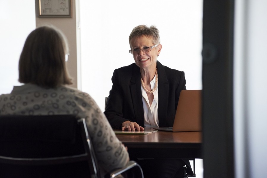 image of two women in a business meeting, smiling