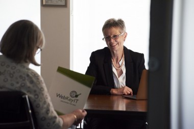 image of two women in a business meeting, smiling